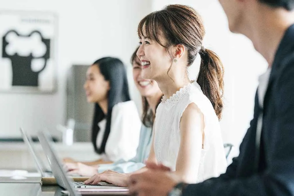 オフィスでパソコンに向かう社会人の女性たち